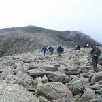 Crossing the boulders on Broad Crag with Scafell Pike behind