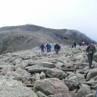 Crossing the boulders on Broad Crag with Scafell Pike behind