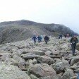 Crossing the boulders on Broad Crag with Scafell Pike behind
