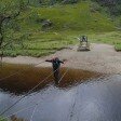 Crossing the wire bridge by Steall Falls